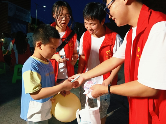 "宣讲会上,学生邹宦荣向村民们讲解安全用电知识.