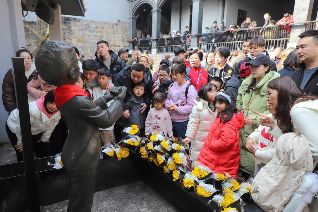 白公館內的小蘿卜頭雕像前，圍滿了瞻仰的游客。記者 楊飛 供圖