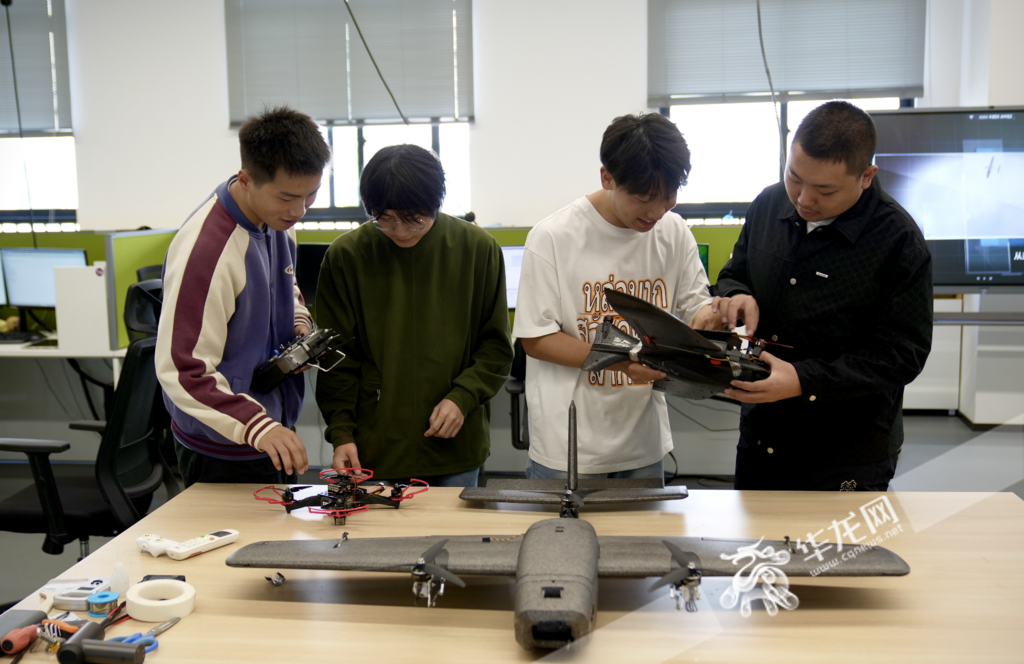 Students focusing on flight equipment in the laboratory