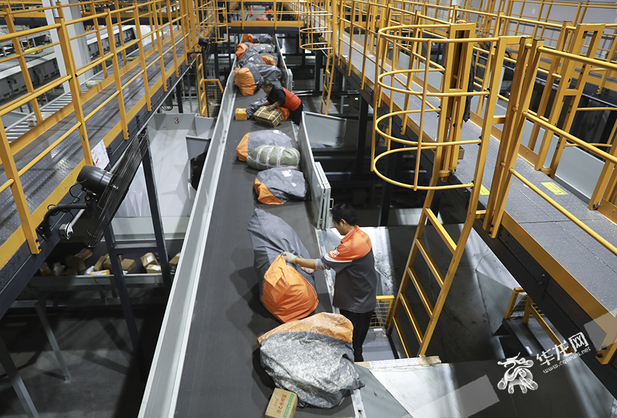 At the Sto Express Chongqing Transfer Center, staff sorting large packages