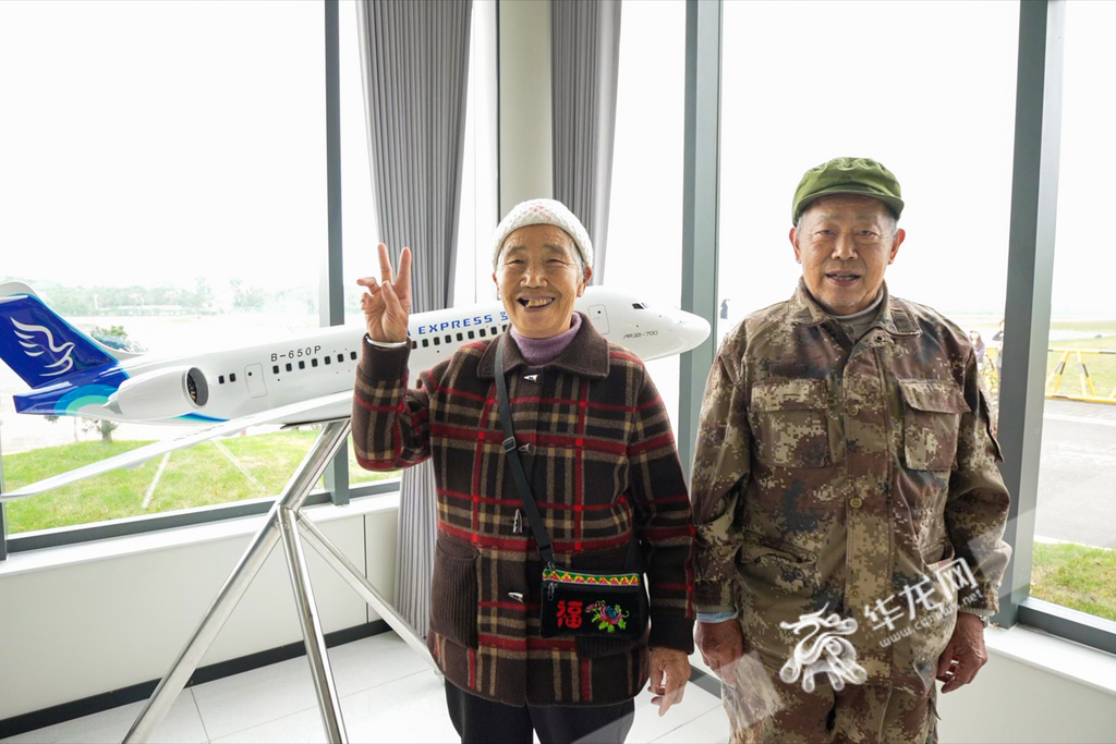 Ren’s grandpa and grandma posed in front of a model airplane