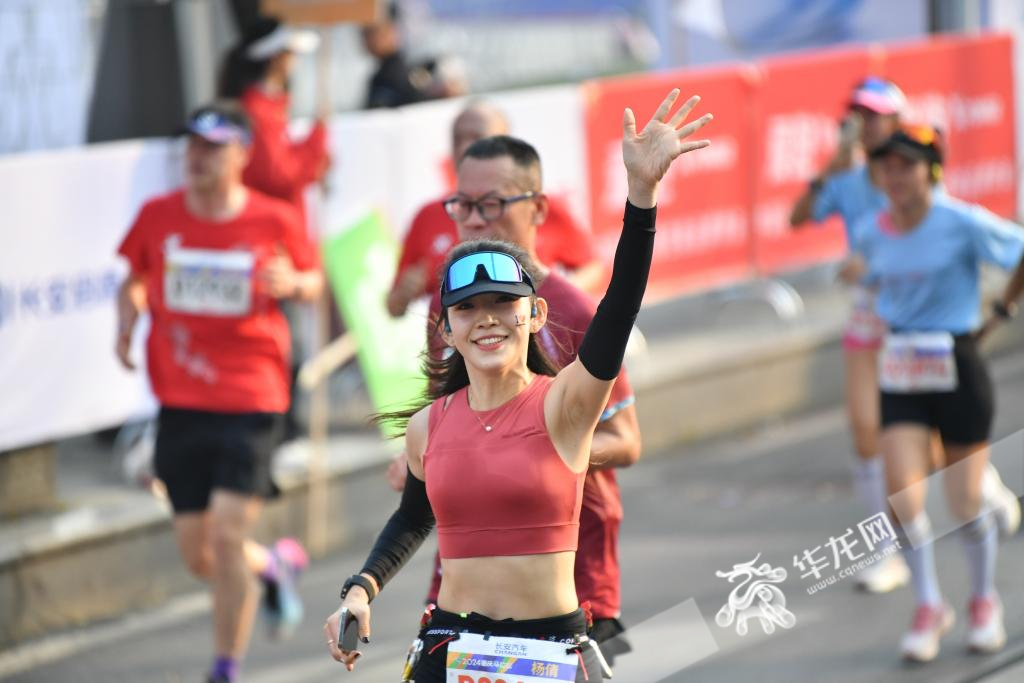 A runner waving her hand to the camera