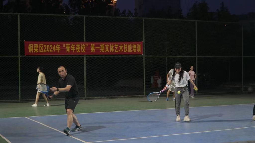 青年夜校网球班学员在努力练习颠球、接球。铜梁区委宣传部供图 华龙网发