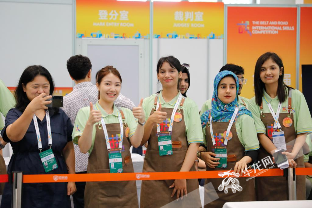 A judge was tasting the coffee made by Xiong Zhe in the Coffee Making Competition Event.  Other competitors were watching the Coffee Making Competition Event.