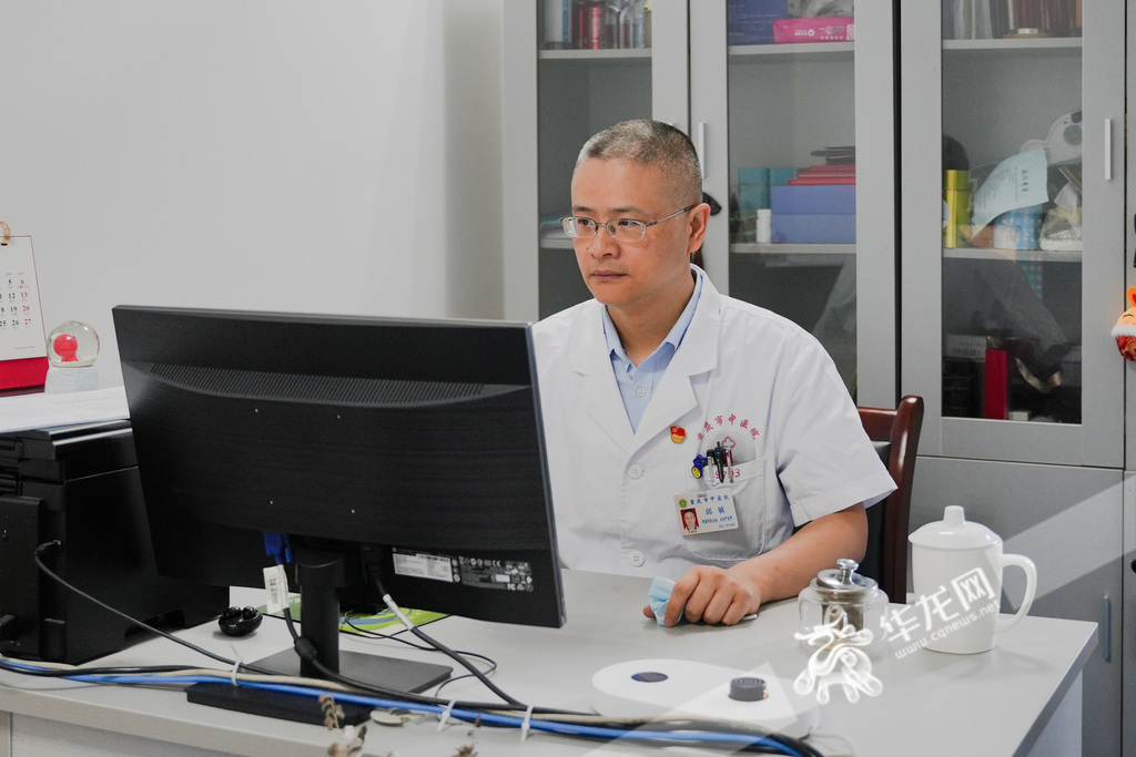 Dr. Qiu Min reviewed medical records in his office