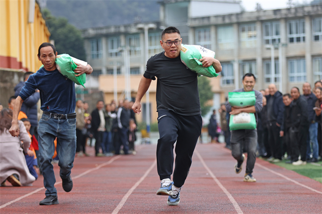 鄉(xiāng)村趣味運動會，村民們進行搬運糧食比賽。通訊員 趙勇 攝