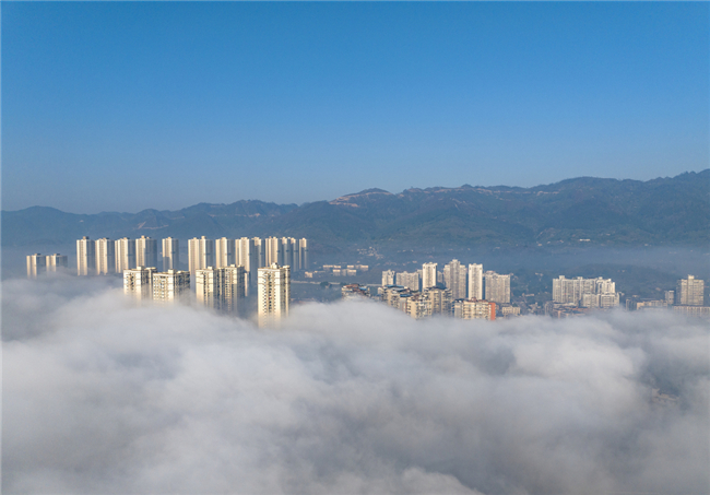 Jinyun Mountain in the distance partly hidden and partly visible enveloped by the cloud sea