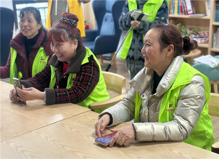 在志愿者赋能培训中，徐廷英与其它志愿者一起学习手机摄影摄像。受访者供图 第1眼TV-华龙网发