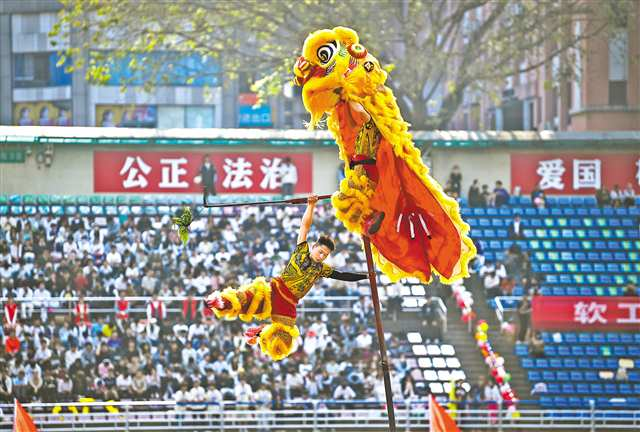 The photo shows the lion dance troupe performing “Dancing Lion Soaring”