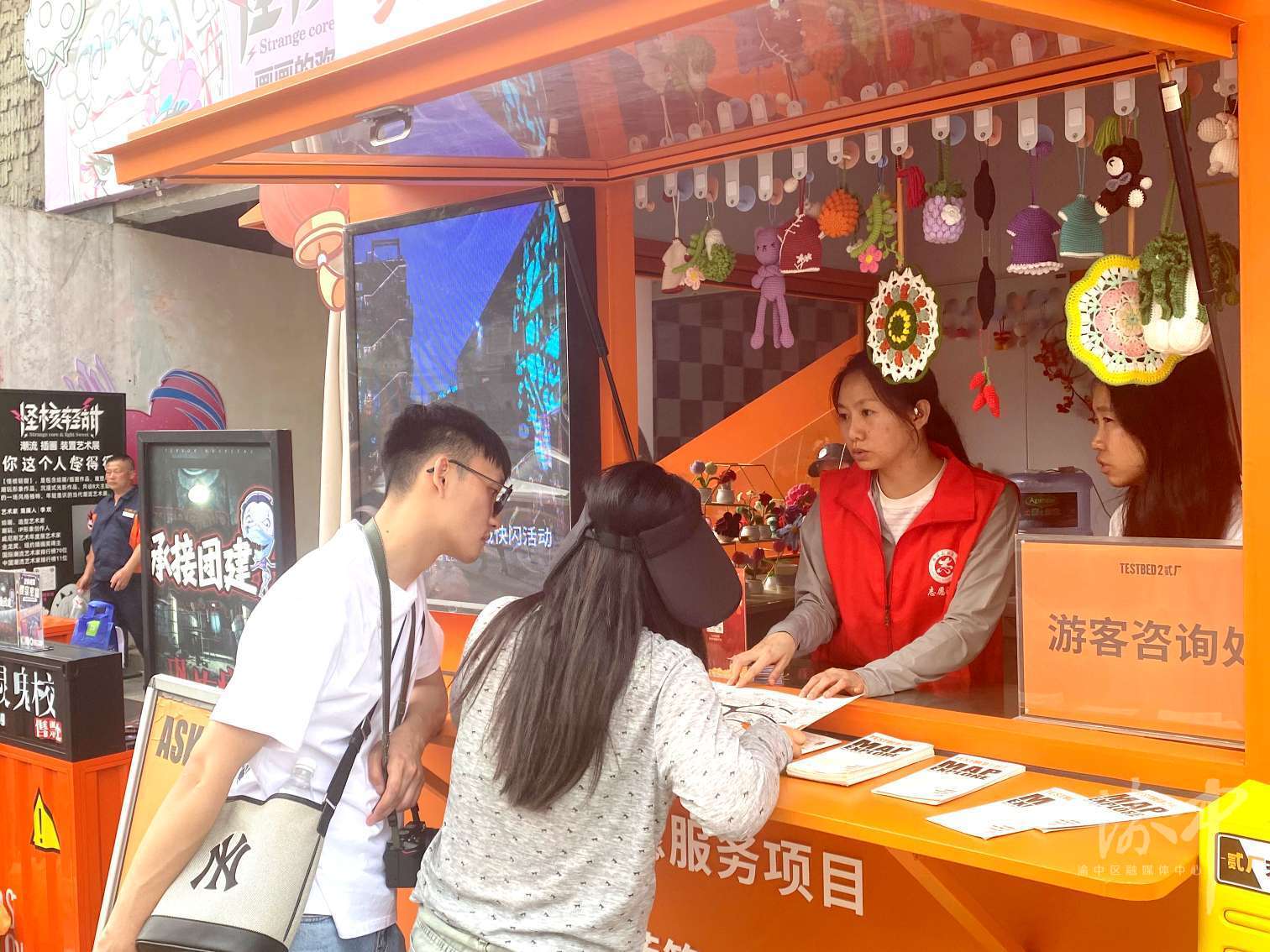 两路口街道“红岩先锋”志愿者服务岗亭，志愿者耐心为游客提供路线咨询指引。