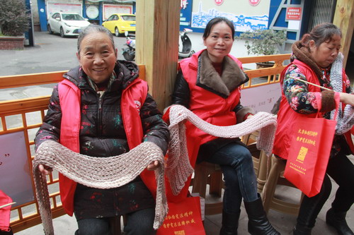 83岁的李丽芳老人展示她编织的围巾。特约通讯员 周云 摄