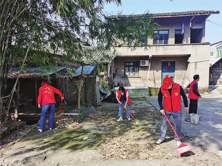 志愿者们正在清洁村庄。通讯员 熊骏仪 摄