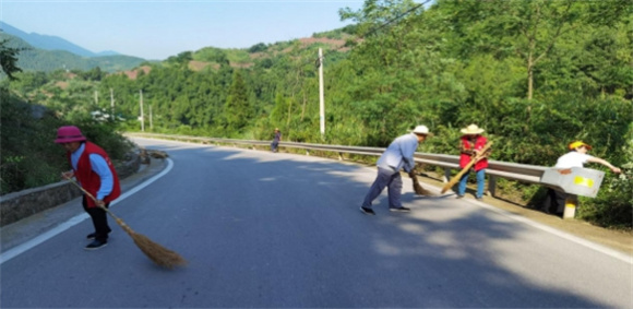 小治村村民正在清扫公路。通讯员 苏炼 摄