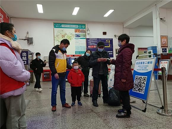 3大足交通志愿者在大足汽车站安检处为乘客临时照看小孩图。通讯员 王弟洪 摄