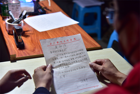 志愿者正在阅读老人给他们写的感谢信。云阳县委宣传部供图 华龙网发
