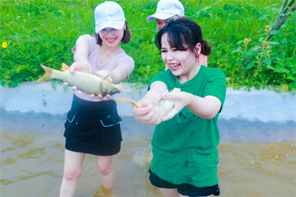 游客在农家乐体验浑水摸鱼活动乐趣。通讯员 刘文静 王嘉琪 摄