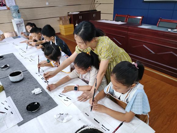书法老师逐一指导学生书写。通讯员 谭晓玲 摄