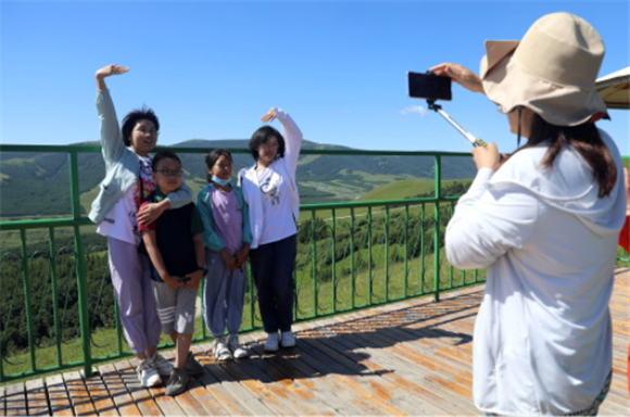 游客在丰宁满族自治县千松坝森林公园景区拍照游玩。新华社记者 骆学峰 摄