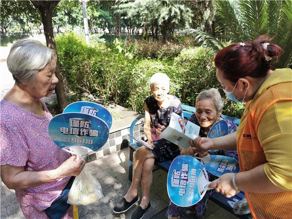 社区养老服务站志愿者为辖区老年群众分发宣传品。通讯员 丘利成 摄