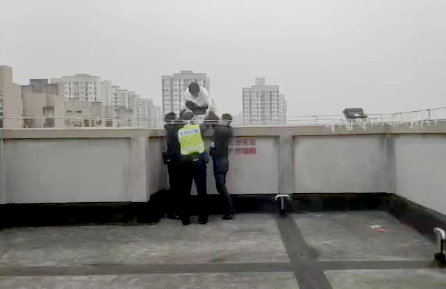 2民警搀扶小陈到安全地带。重庆高新区警方供图