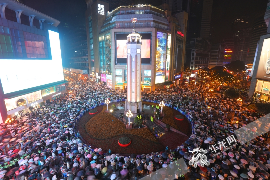People gathered under the Monument to the People's Liberation (Jiefangbei) in the rain at 10 p.m. on December 31, waiting for the New Year.