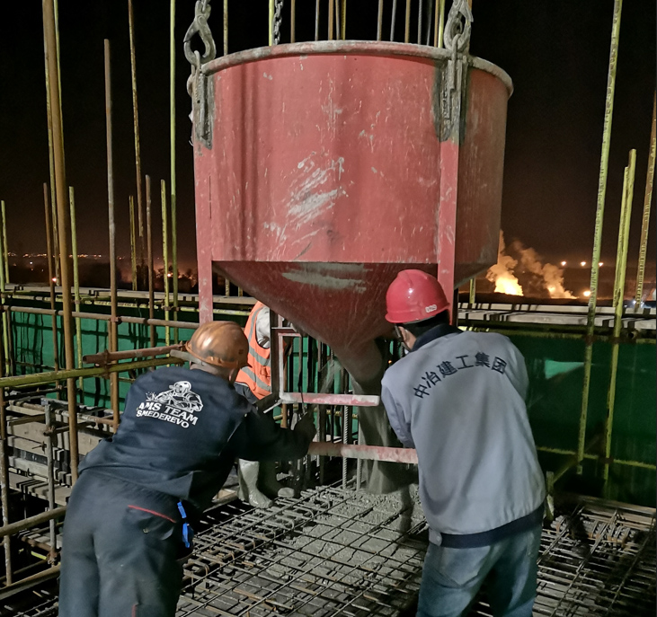 Workers from China and Serbia pouring concrete together. (Photo provided by the interviewee)