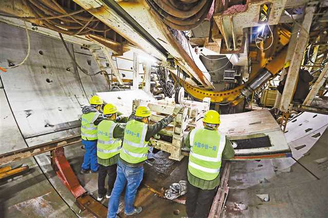 At Xiuhulu Station of Phase I of Chongqing Urban Rail Express Line 15, technical workers of China Railway are assembling segments in TBM tunnelling machine. (Photographed by Luo Bin / Visual Chongqing)