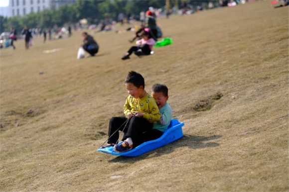 广阳湾智创生态城，小朋友在草坪上开心玩耍。记者 郭旭 摄