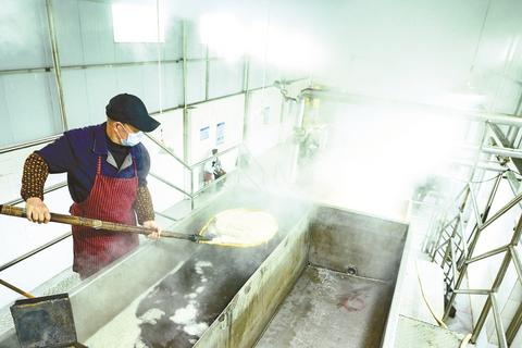 甘蔗汁经沉淀后入锅高温熬煮。记者 袁孝椿 摄 (2)