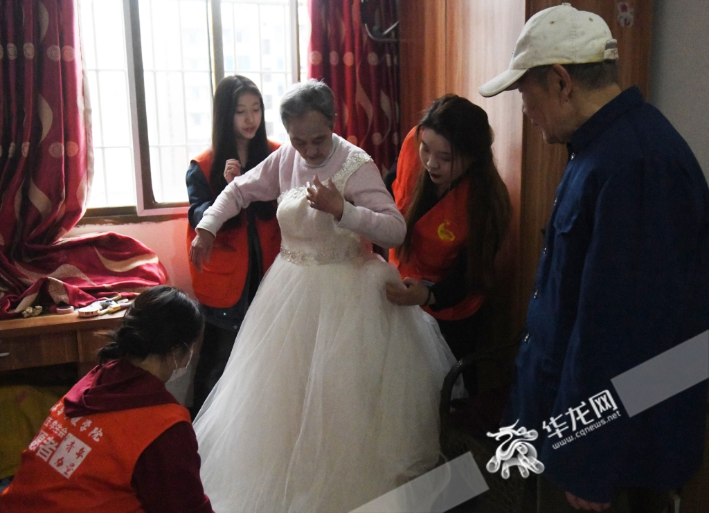 老人正在穿婚纱。华龙网-新重庆客户端 记者 秦思思 摄