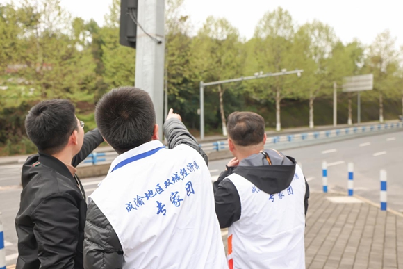 武强及团队成员在重庆国家应用数学中心示范路口进行考察。重庆高新区政务服务和社会事务中心供图