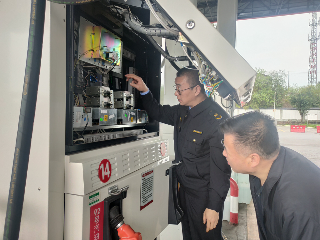 执法人员检查加油机计量设备。渝北区市场监管局供图