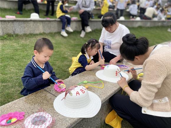 3家长和孩子们一起装饰草帽。虎溪街道供图