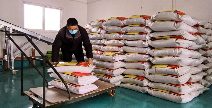 工人在清点整理袋装大米。记者 谢峁燃 摄