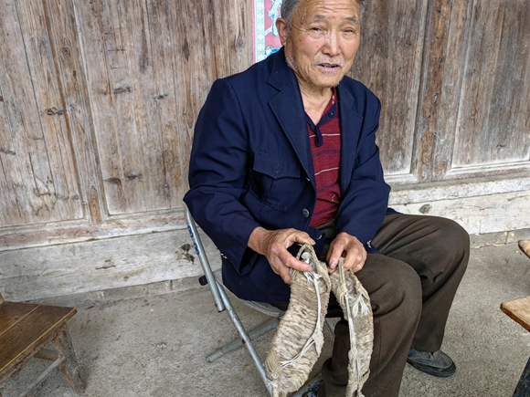 胡代林展示當年拉纖穿的草鞋。華龍網—新重慶客戶端記者 李天春 攝