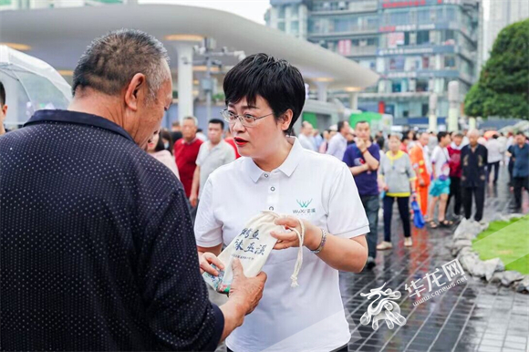 巫溪县政协副主席罗兴莉在观音桥步行街与市民聊得热络。华龙网-新重庆客户端记者 李成 摄