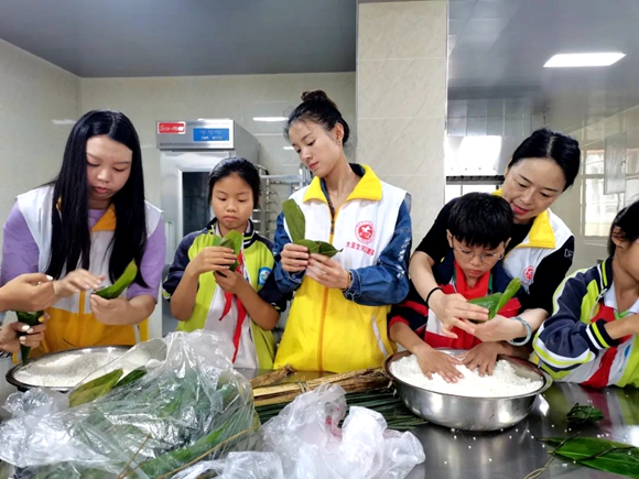 文化志愿者们与孩子们一起包饺子。 大足区委宣传部供图 华龙网发