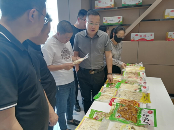 调研团队在宏川食品公司实地调研加工食品。奉节县乡村振兴局供图 华龙网发