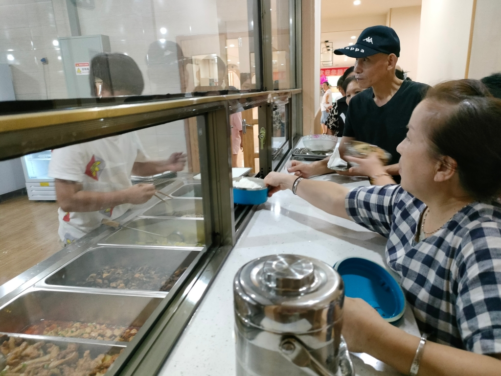 美丽阳光家园公租房居民在养老服务中心取餐。重庆市住房城乡建委供图