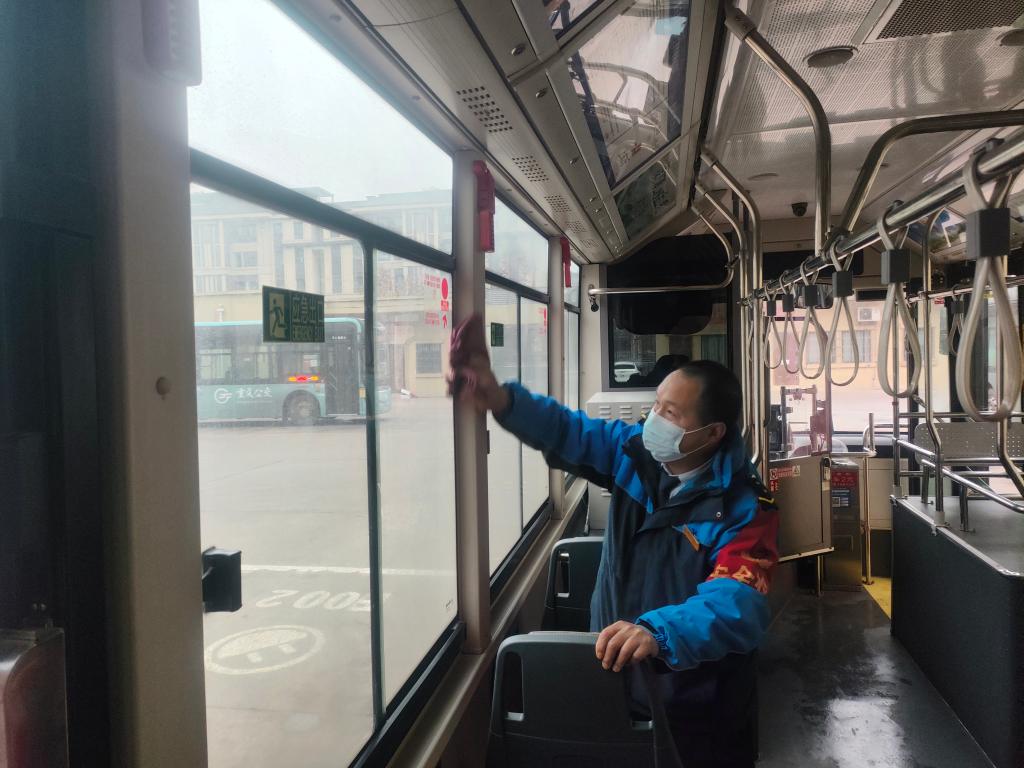 公交398路驾驶员罗小平打扫车厢清洁，保障乘客舒适出行。重庆南部公交供图