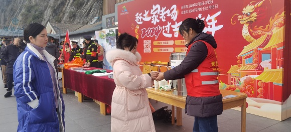 游客接过热腾腾的姜茶。通讯员 黄晓惠 摄