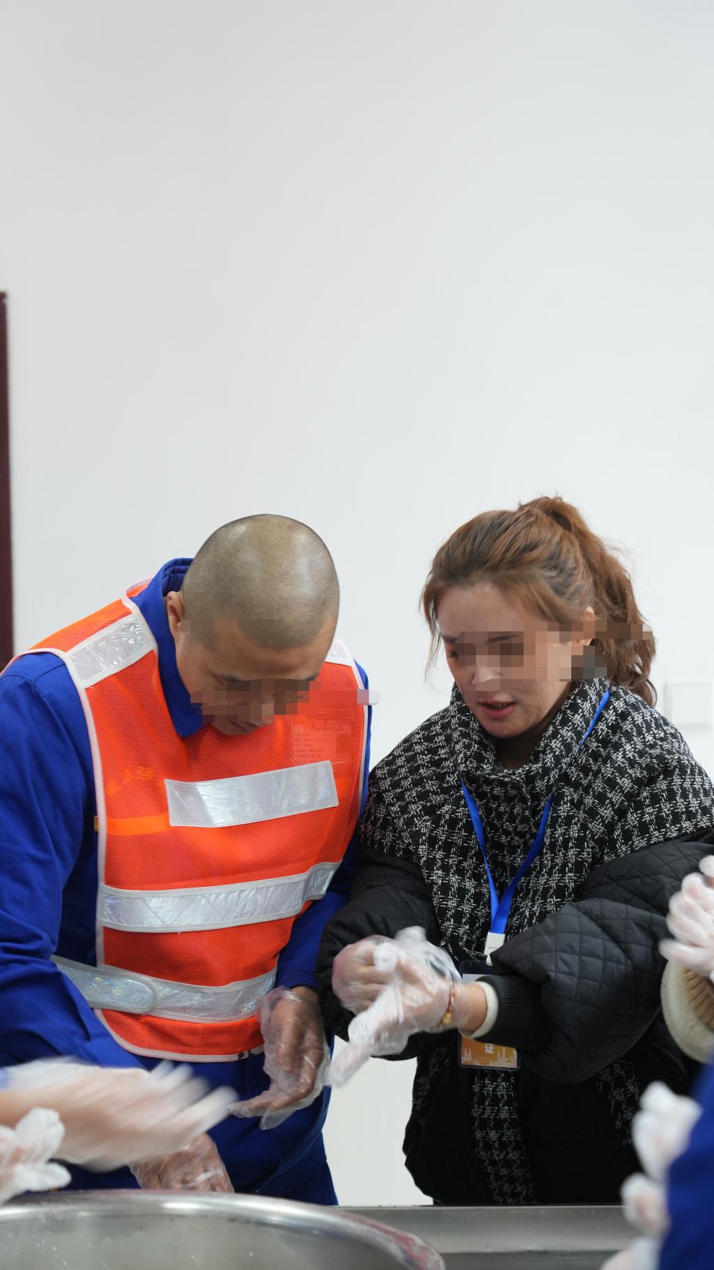 马磊（化名）和妻子边包汤圆边聊着近况。重庆市江北强制隔离戒毒所供图