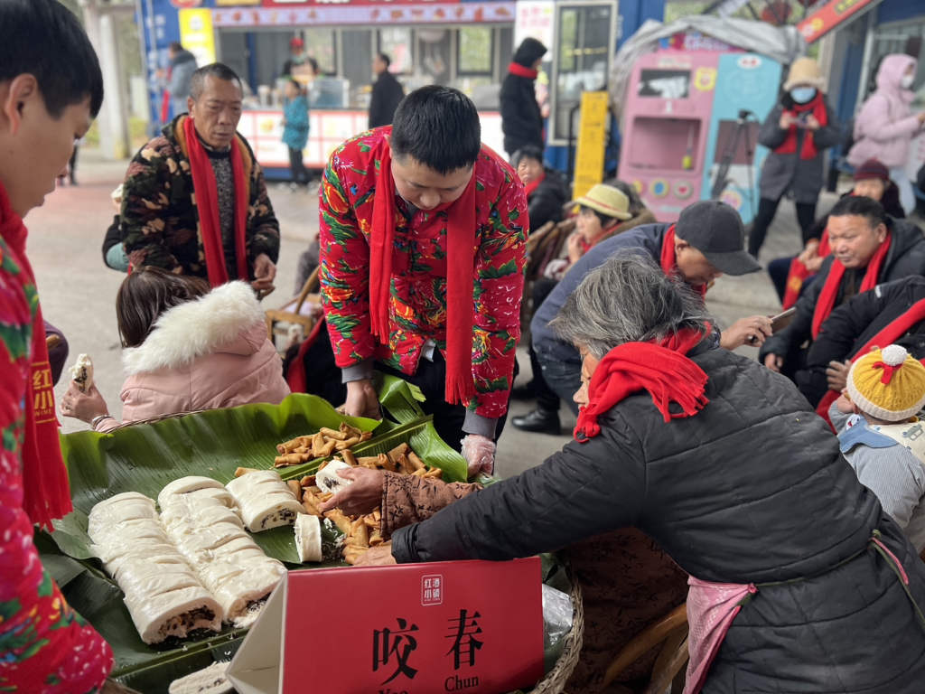 游客、村民体验“咬春卷”。景区供图