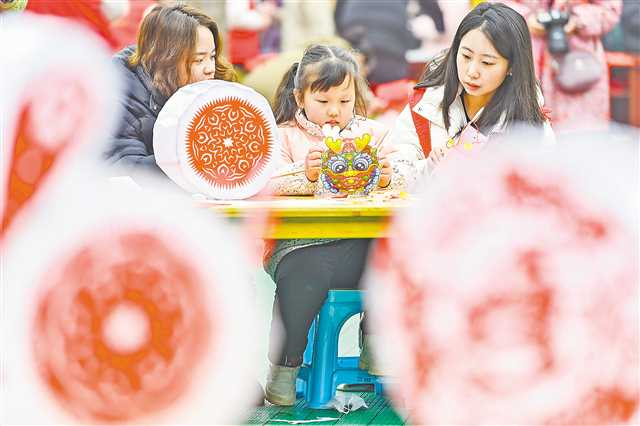 A mother experienced paper-cutting with her child at ‘Our Chinese Spring Festival’ cultural activity in Zhengxing Town, Bishan District on February 1. (Photographed by Qi Lansen / Visual Chongqing)