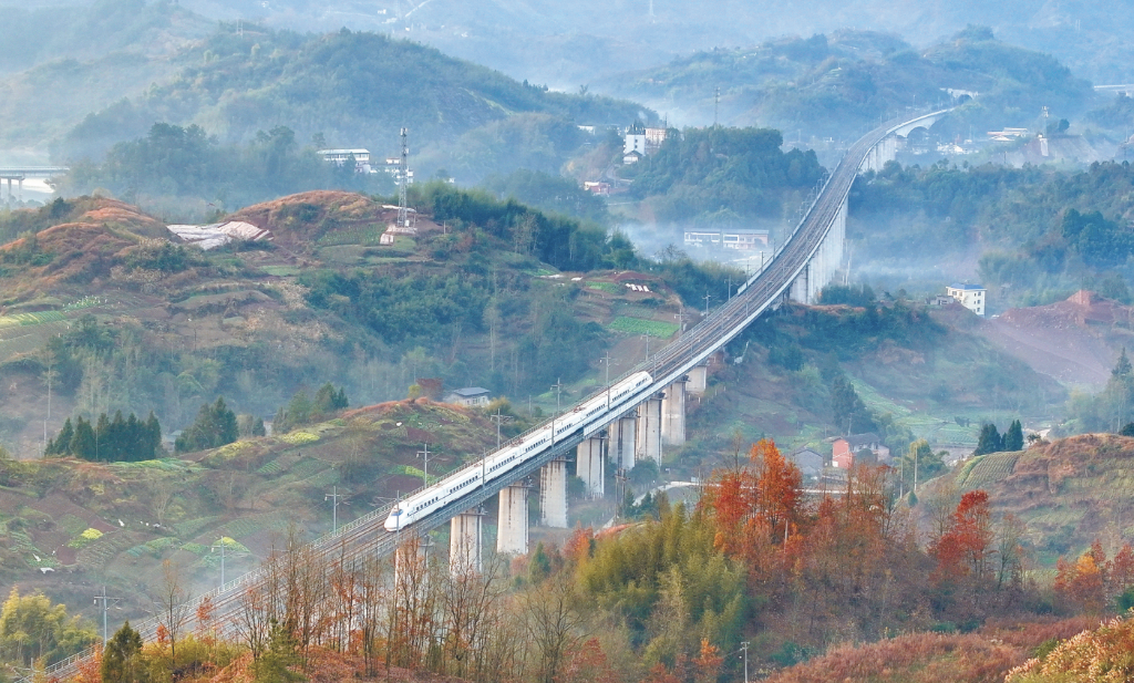 A train hurtling past, creating a beautiful scene with fields and farmhouses